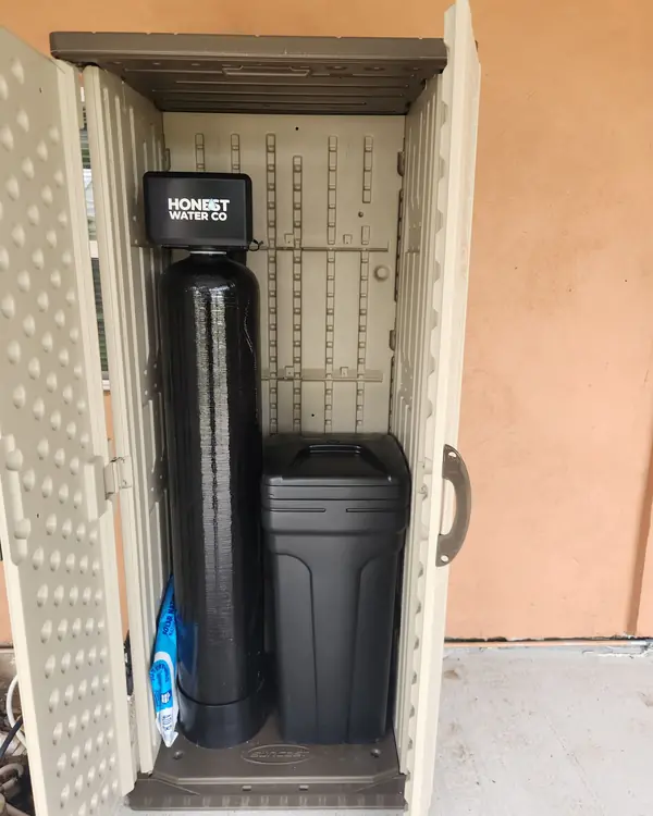 Honest Water Co water softener installed in an outdoor enclosure