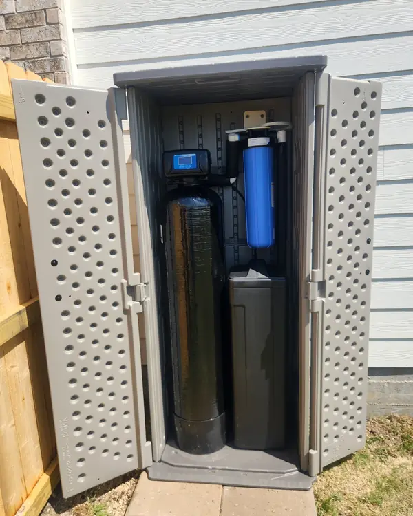 Water softener and whole-home filter installed in an outdoor enclosure