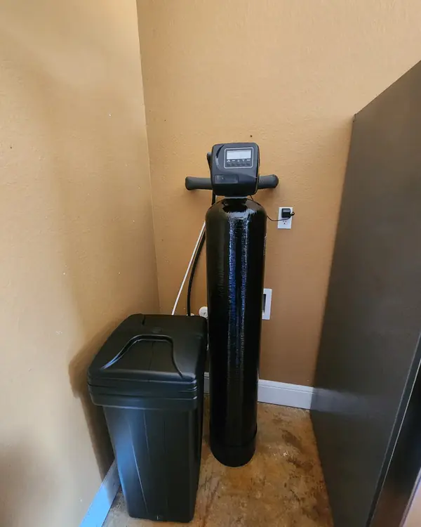 Water softener installed in an indoor utility closet