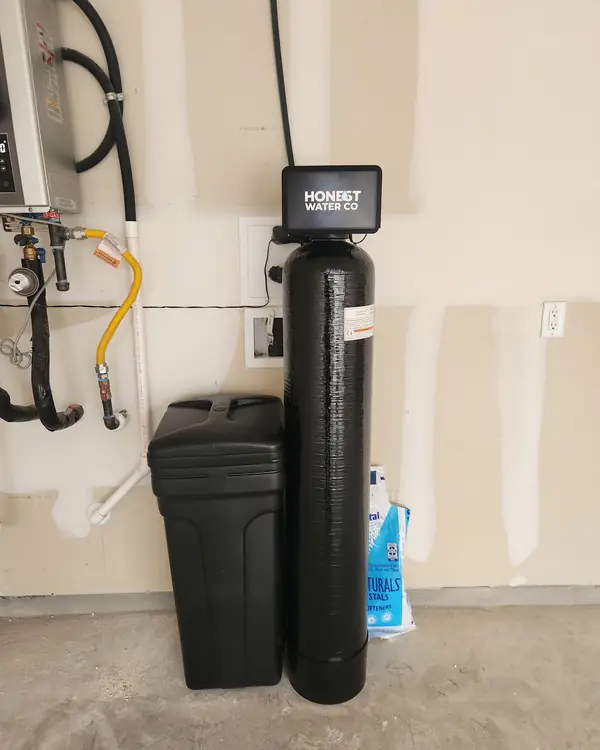 Honest Water Co water softener installed in a garage