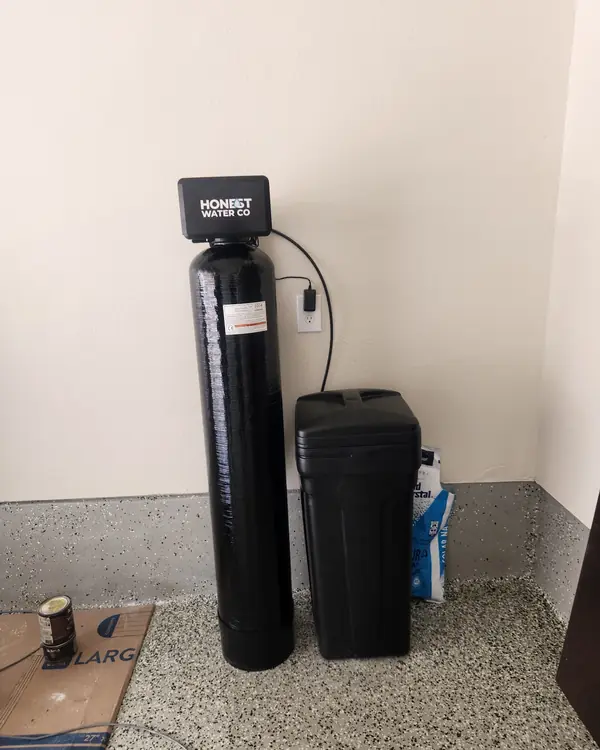 Honest Water Co water softener installed on an epoxy garage floor
