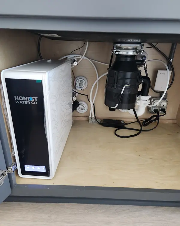Honest Water Co tankless reverse osmosis system next to a garbage disposal