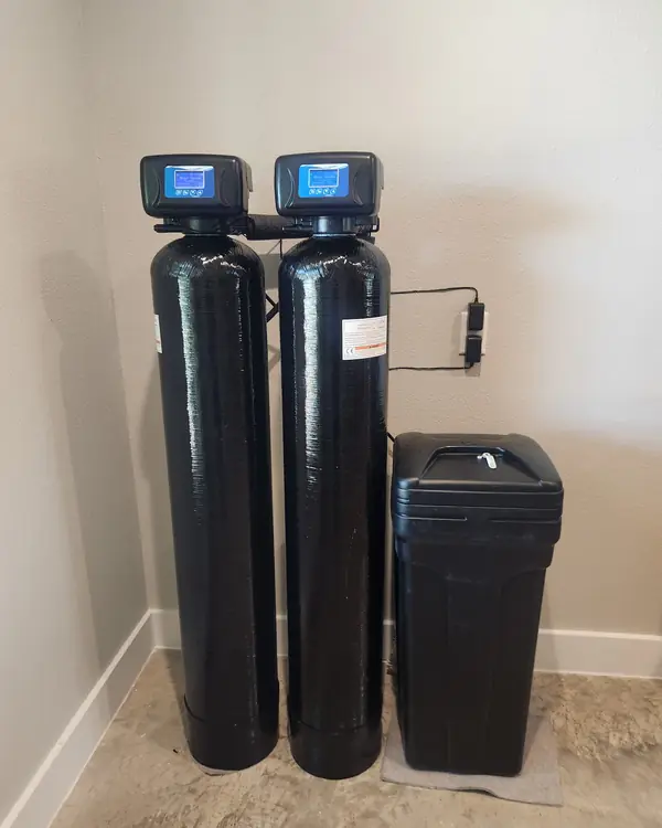 Two-tank water treatment system with brine tank in a utility room