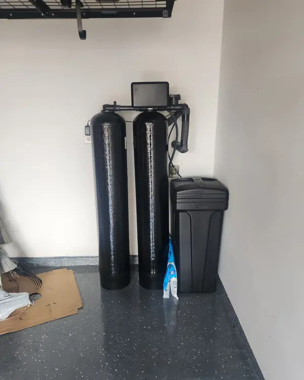 Two-tank water treatment system on an epoxy garage floor